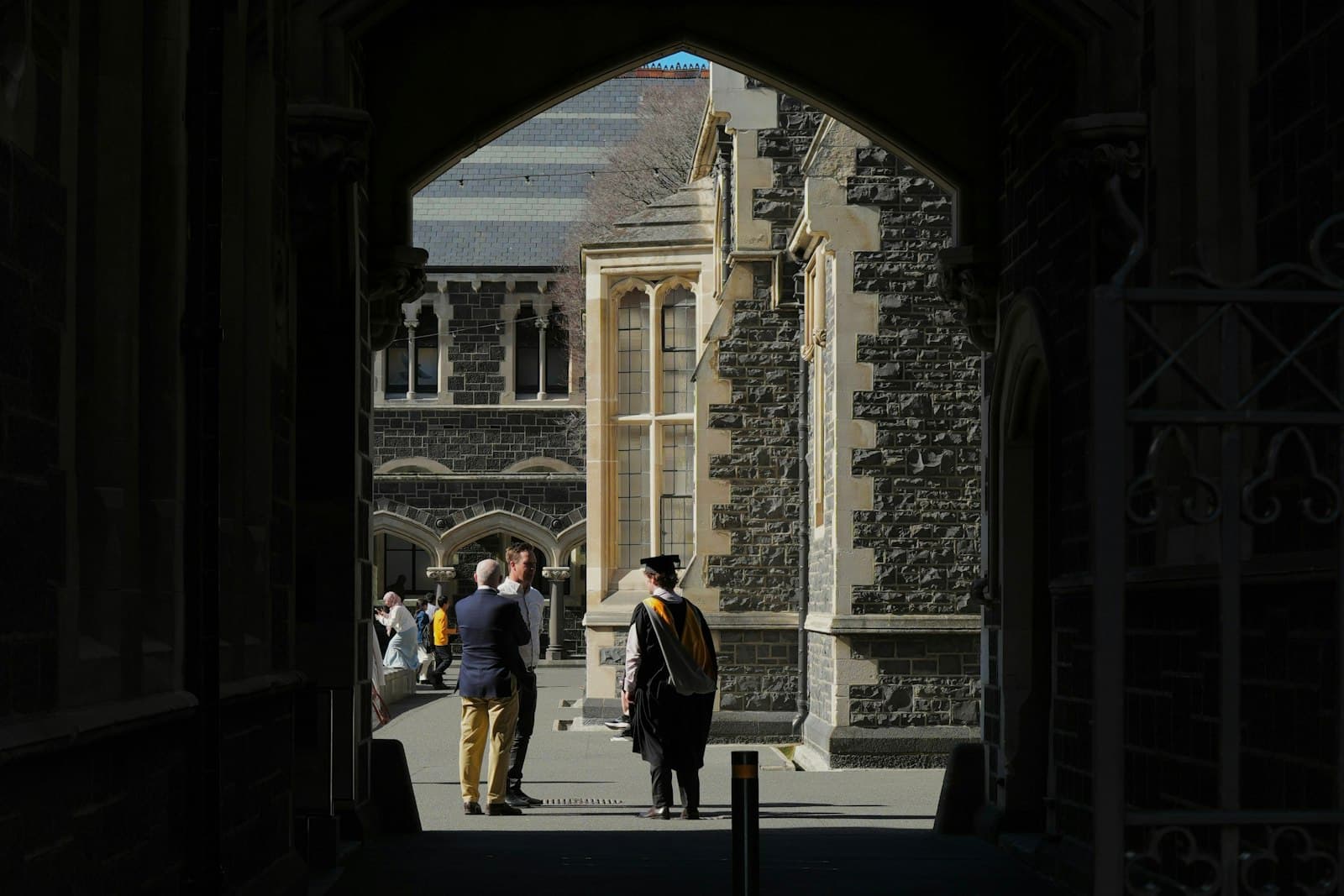 Students walking across a university campus with mountains visible in the distance